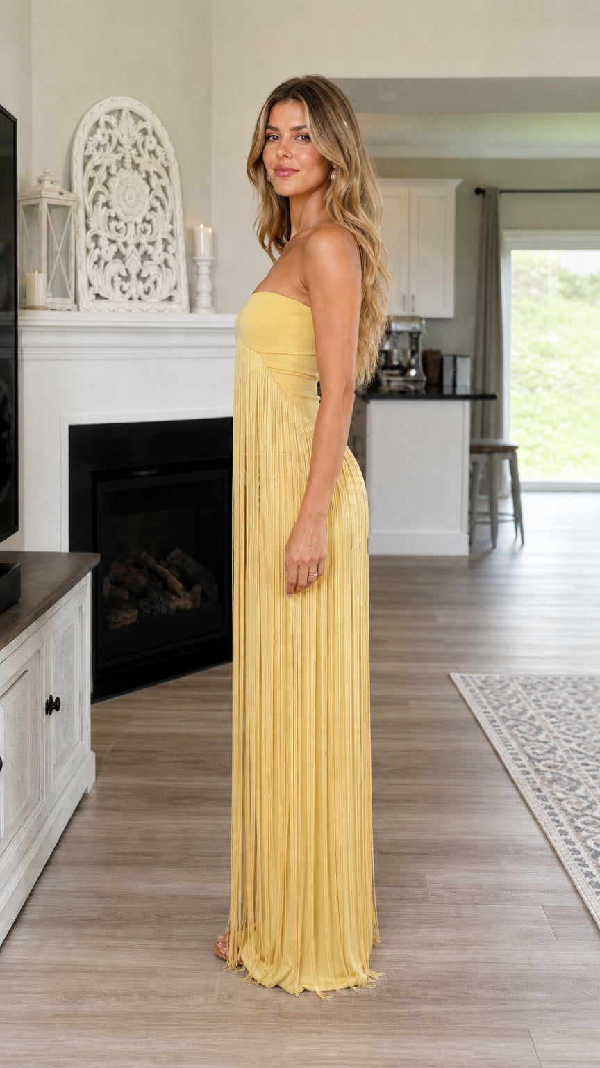 Side view of yellow strapless fringe maxi dress