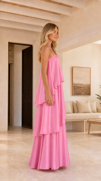 Side profile of model in pink tiered ruffle slip maxi gown