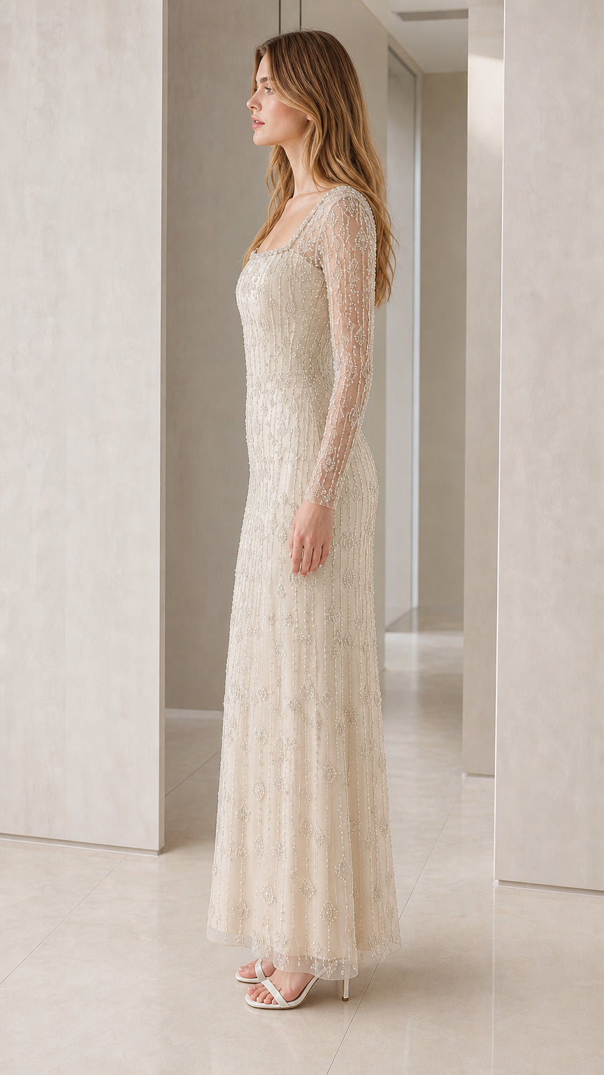 Side view of Champagne beaded long sleeve floor-length evening gown