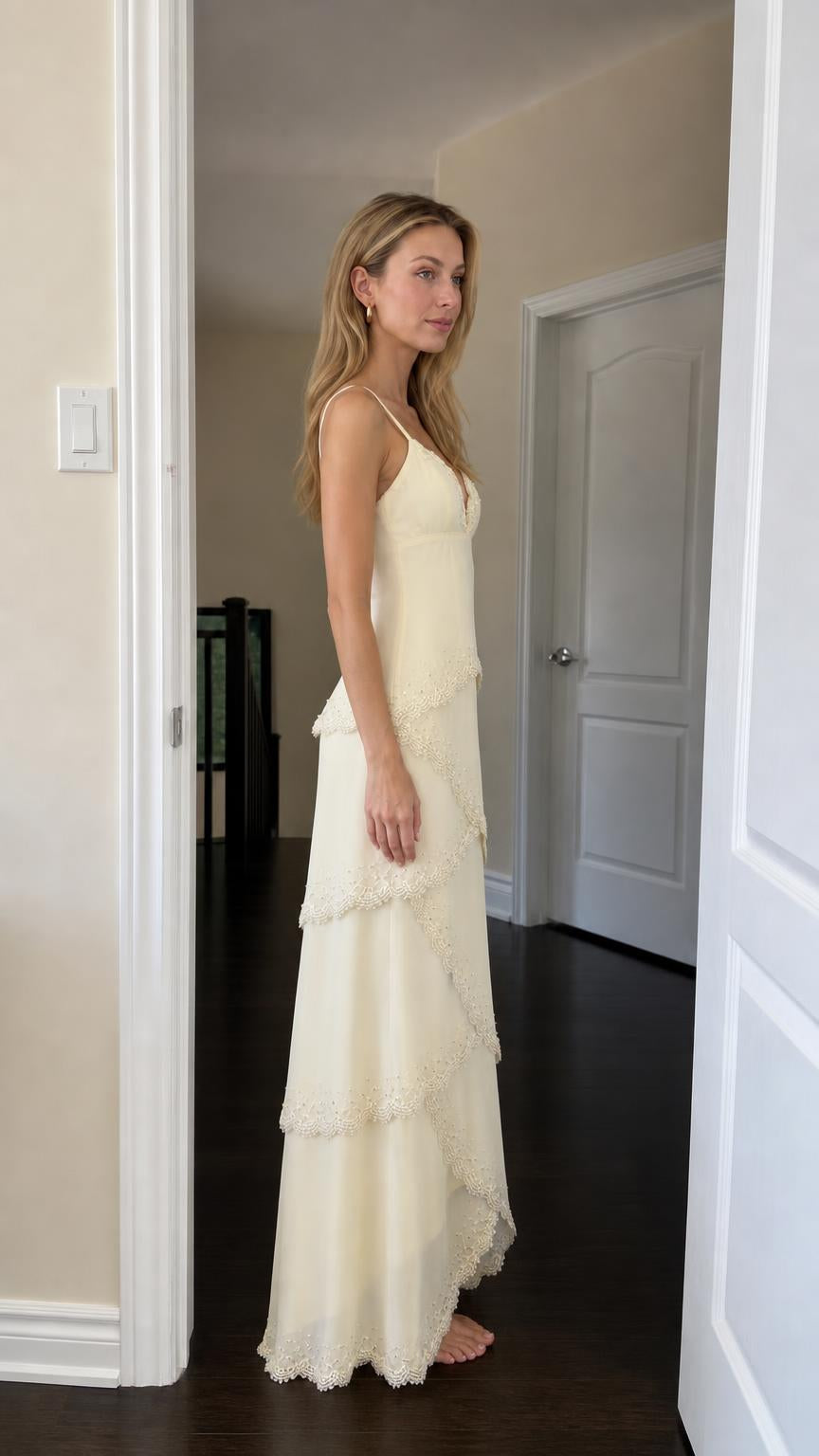 Side profile view of woman in yellow tiered maxi dress
