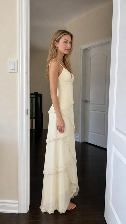 Side profile view of woman in yellow tiered maxi dress