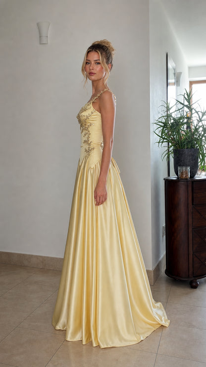 Side profile view of yellow formal ball gown