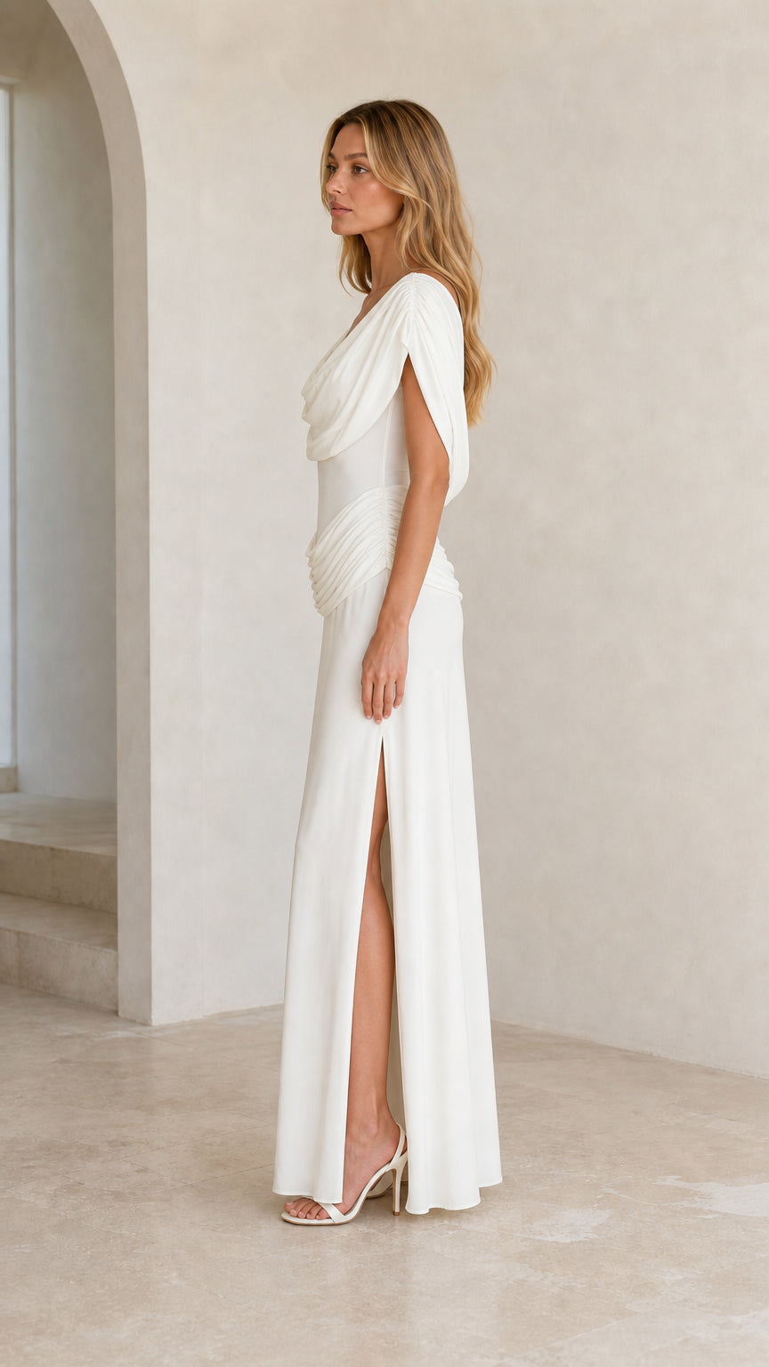 Side profile view of White evening gown highlighting draped neckline