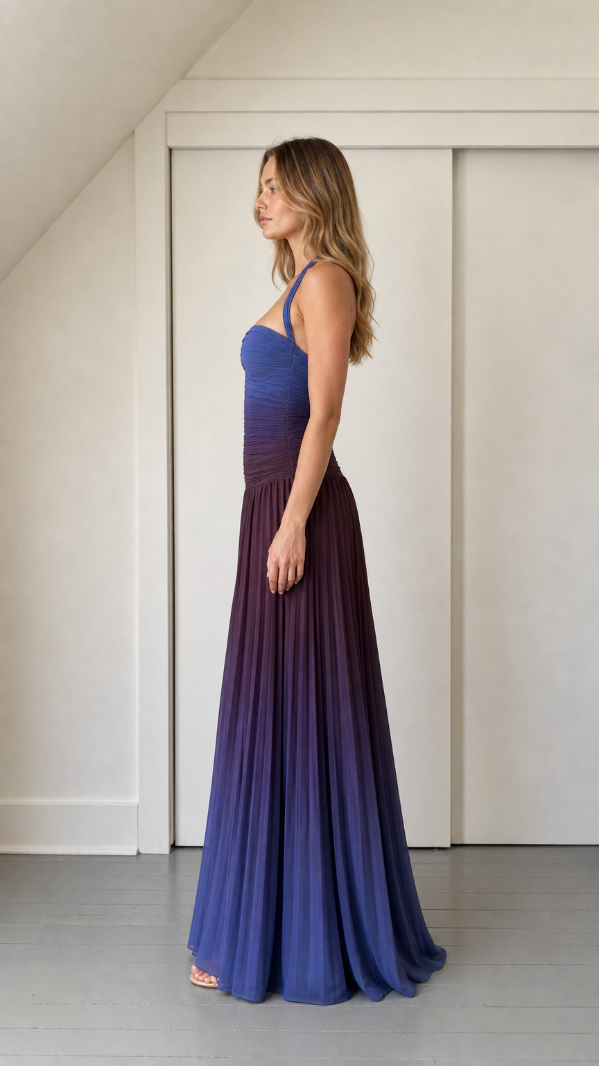 Side profile view of blue ombre pleated maxi dress