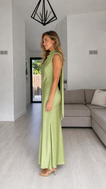 Side profile of model in sage satin maxi dress