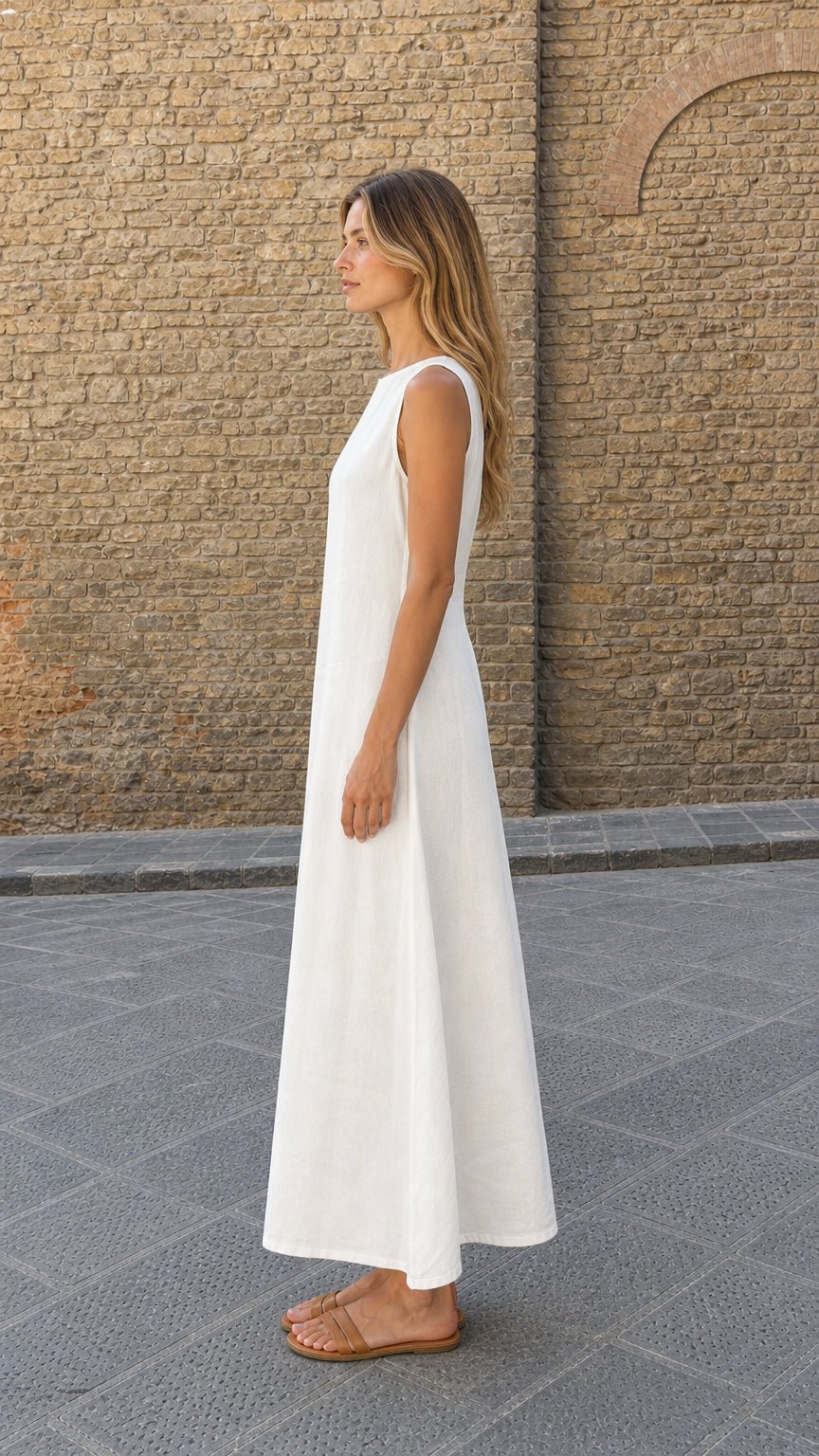Side profile view of model wearing white linen maxi dress