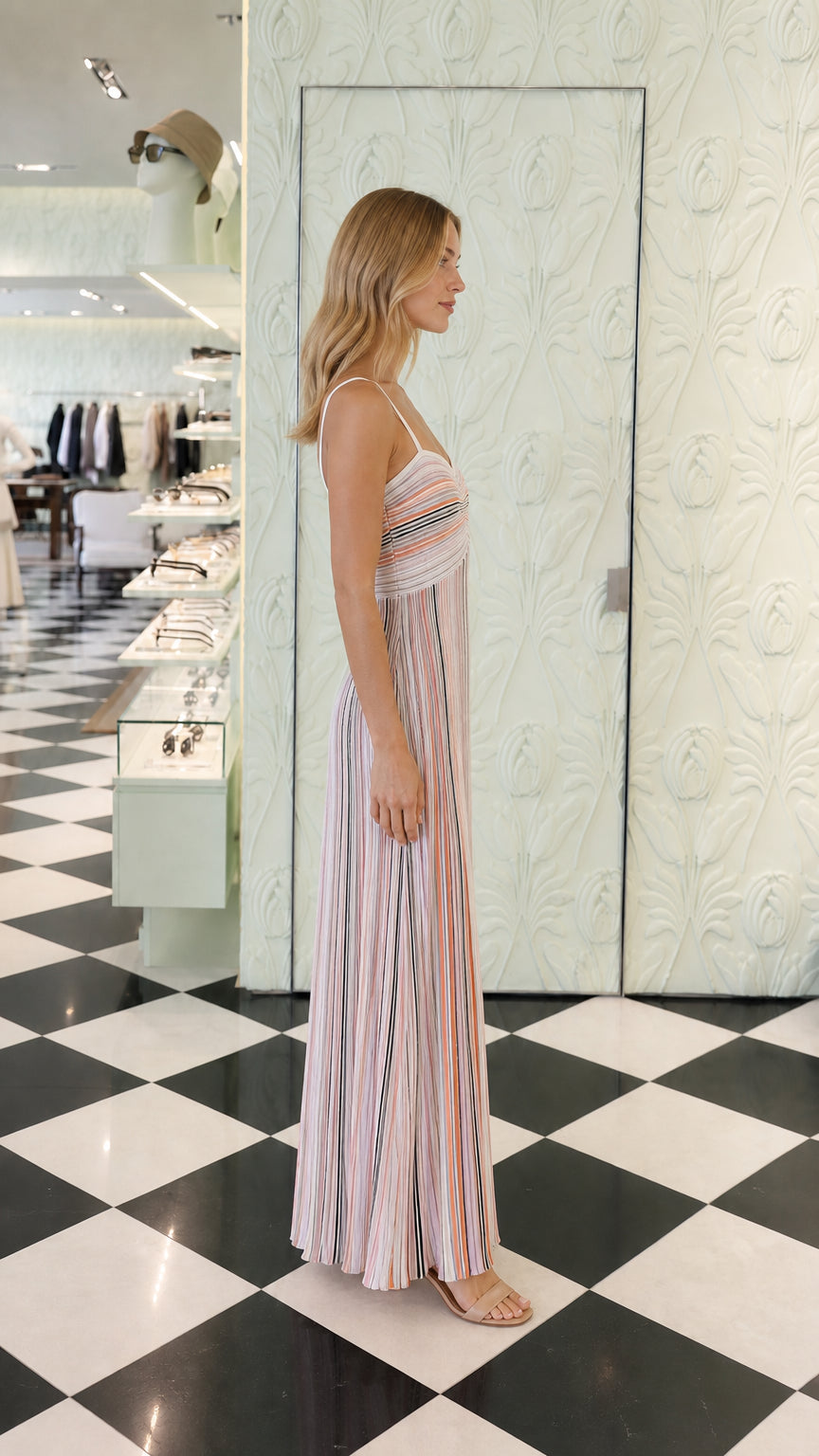 Side profile view of multi pink striped maxi dress