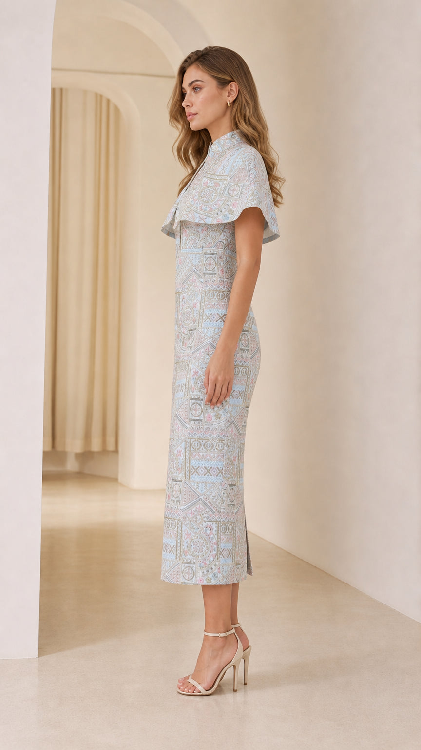 Side profile of model in Light Blue capelet sheath midi dress