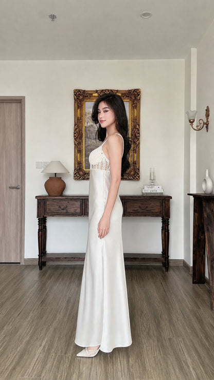 Side profile view of white satin slip dress