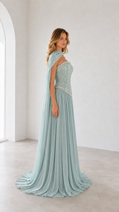 Side profile view of sage green evening gown with flowing cape