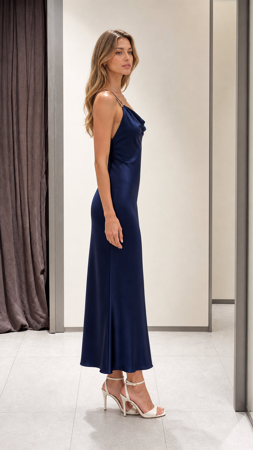 Side view of a navy cowl neck maxi dress showing its fluid slim silhouette