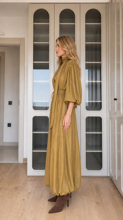 Side profile view of mustard draped balloon leg jumpsuit