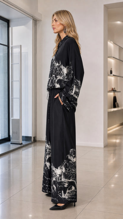 Side profile view of black sketch print two-piece shirt and wide-leg trousers outfit