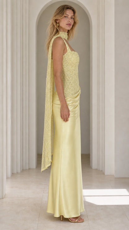 Side profile view of yellow evening gown with scarf