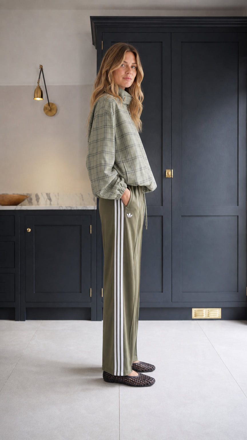 Sage green plaid zip-up jacket side view paired with track pants