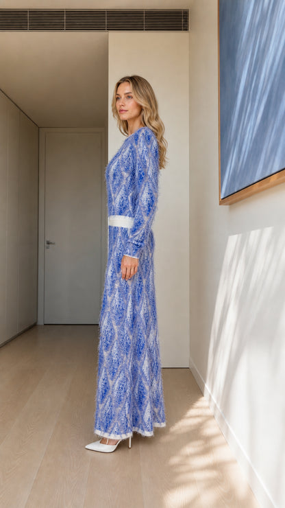 Side profile of model in blue textured knit dress