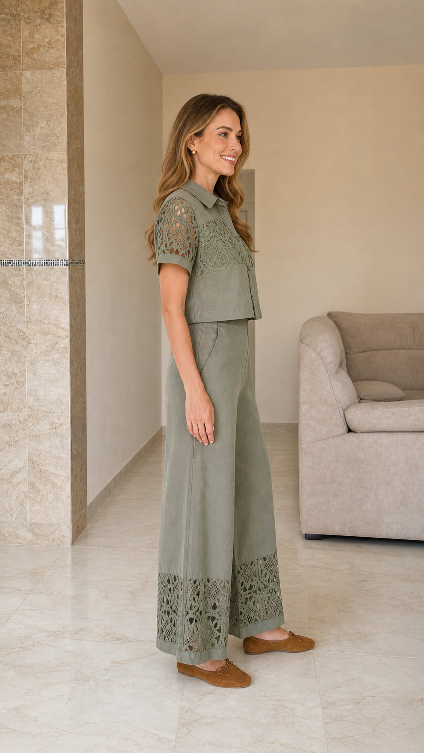 Sage green two-piece outfit shown from the side with wide-leg trousers