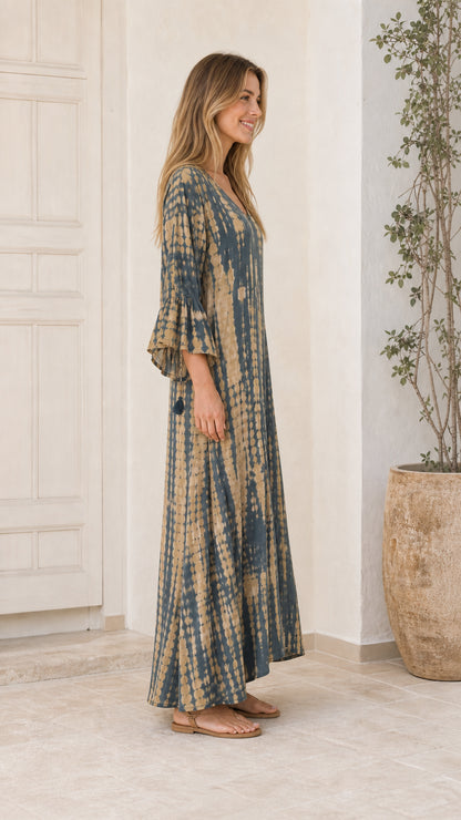 Side profile of model wearing Blue tie-dye maxi dress