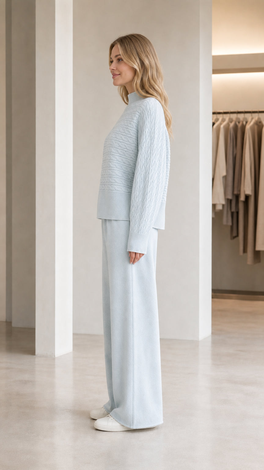 Side profile view of model wearing light blue textured mock neck sweater