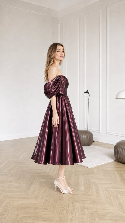 Side profile view of burgundy metallic midi dress