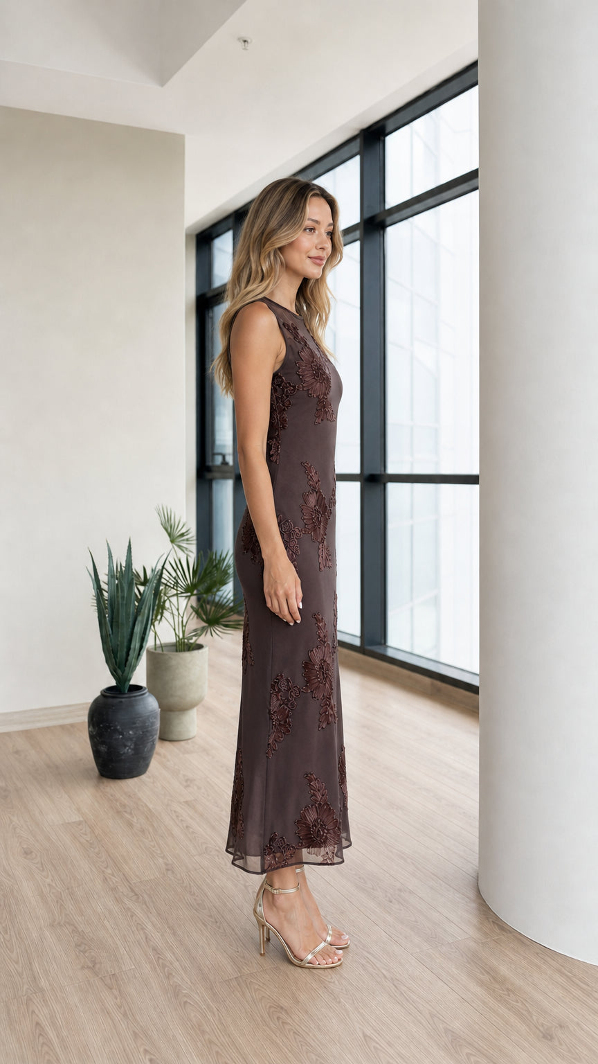 Side profile of model in dark brown mesh midi dress