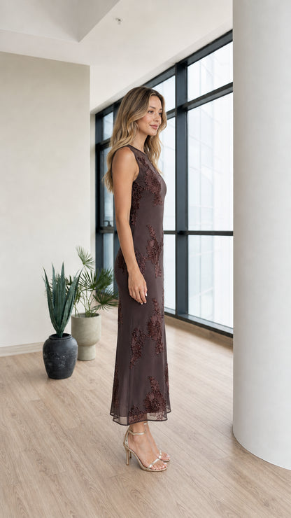 Side profile of model in dark brown mesh midi dress