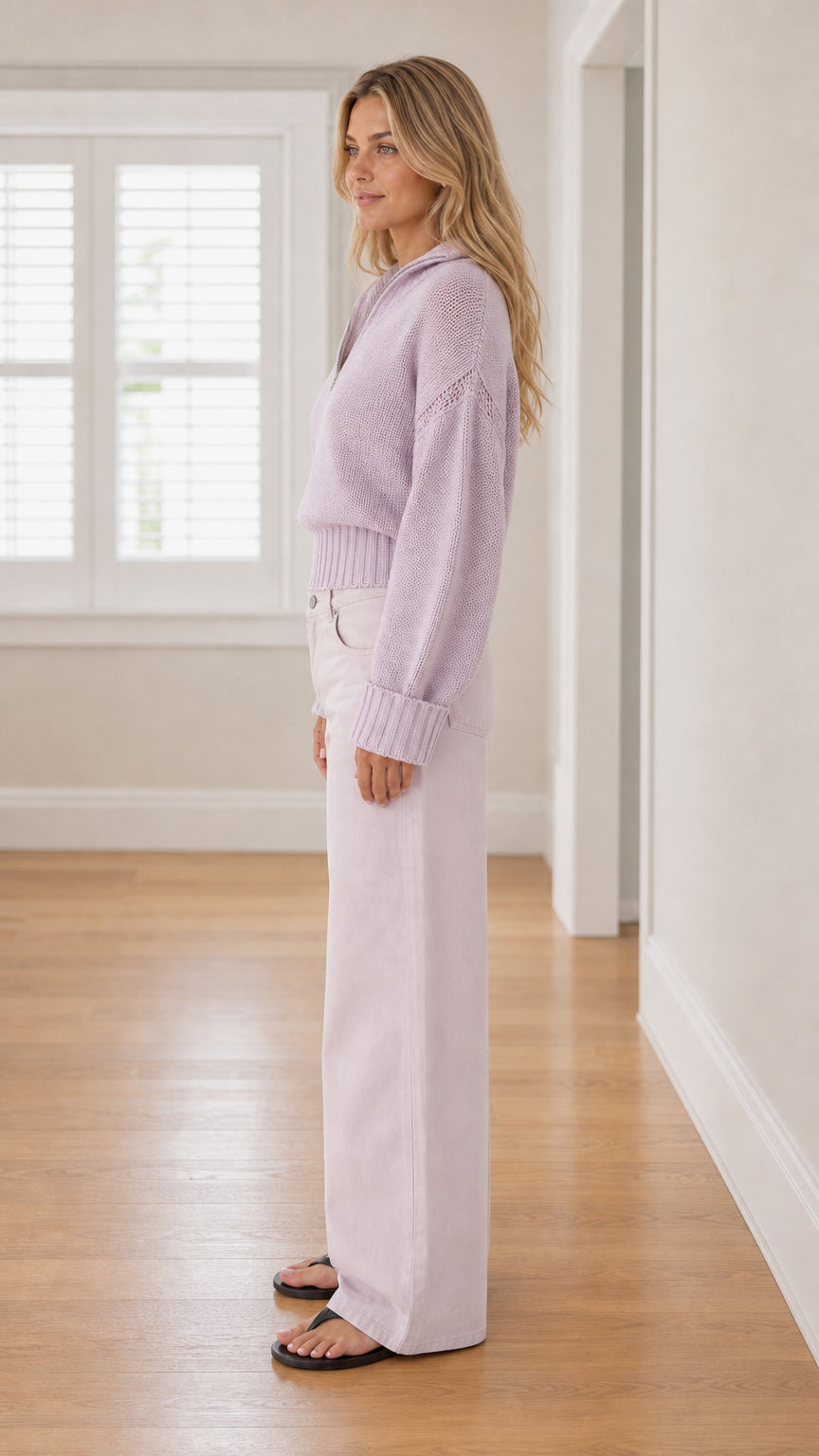 Side profile of model wearing lavender half-zip ribbed sweater