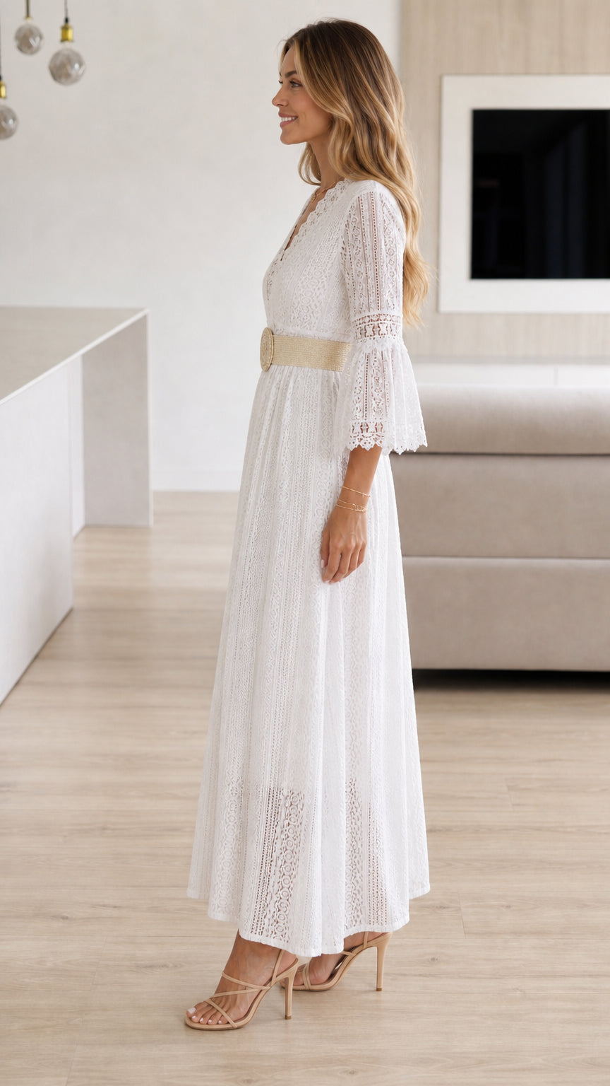 Side profile of model wearing white lace maxi dress