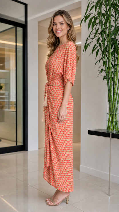 Side profile view of orange geometric print maxi dress
