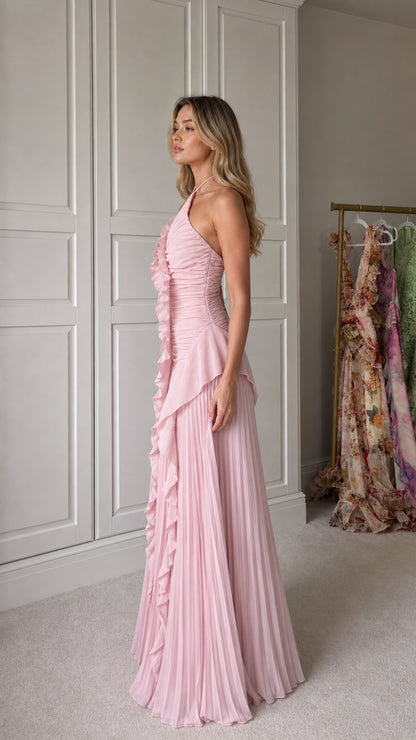 Side profile of model in pink pleated maxi dress