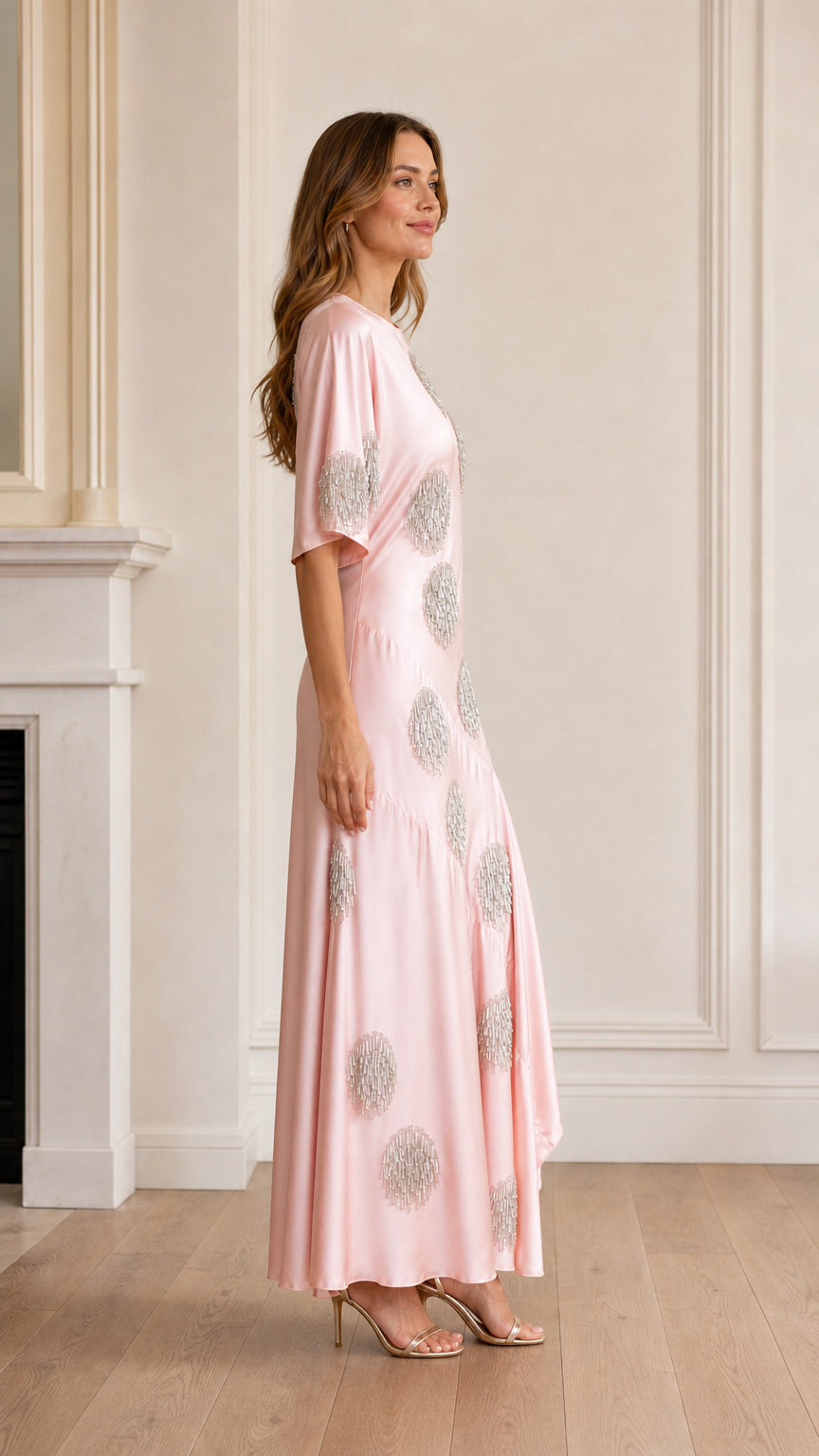 Side profile view of pink satin maxi dress