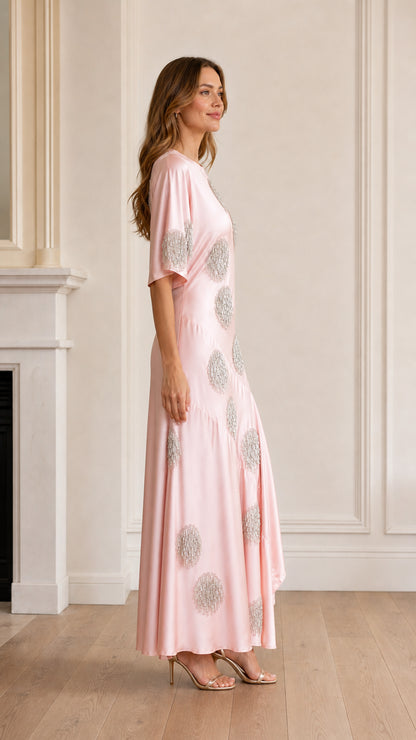 Side profile view of pink satin maxi dress