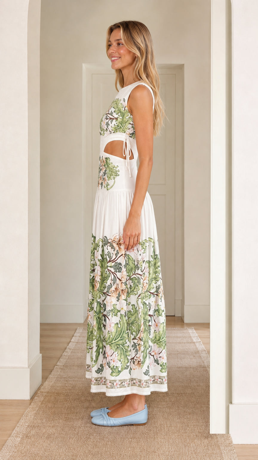 Side profile of woman wearing white floral print cutout maxi dress