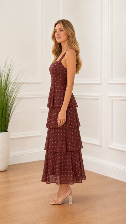 Side profile of model in burgundy polka dot midi dress