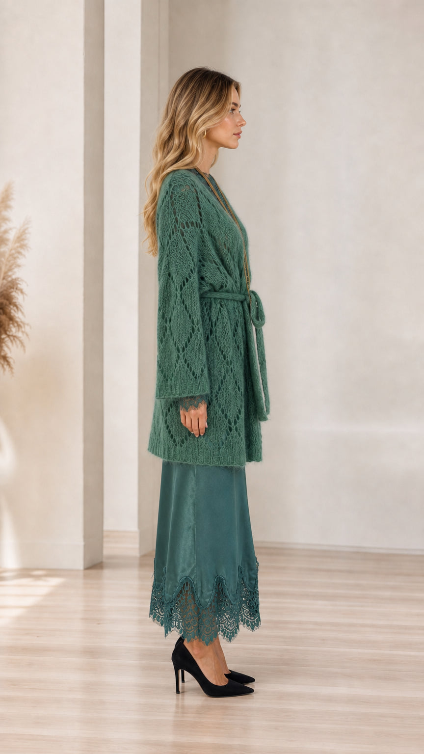 Model wearing green cardigan, side view