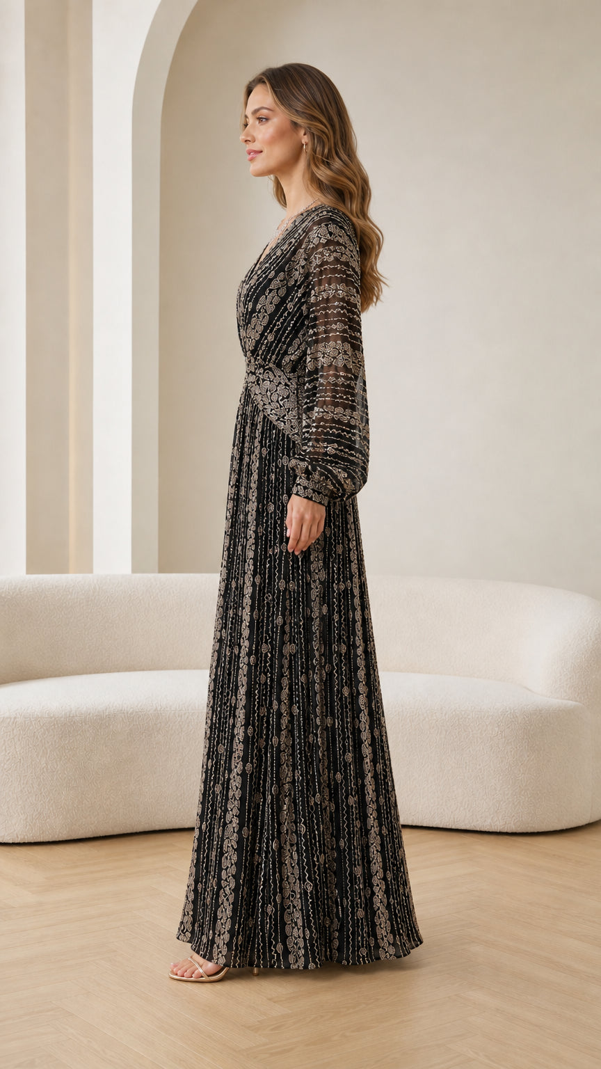 Side profile view of woman modeling black embellished pleated evening gown
