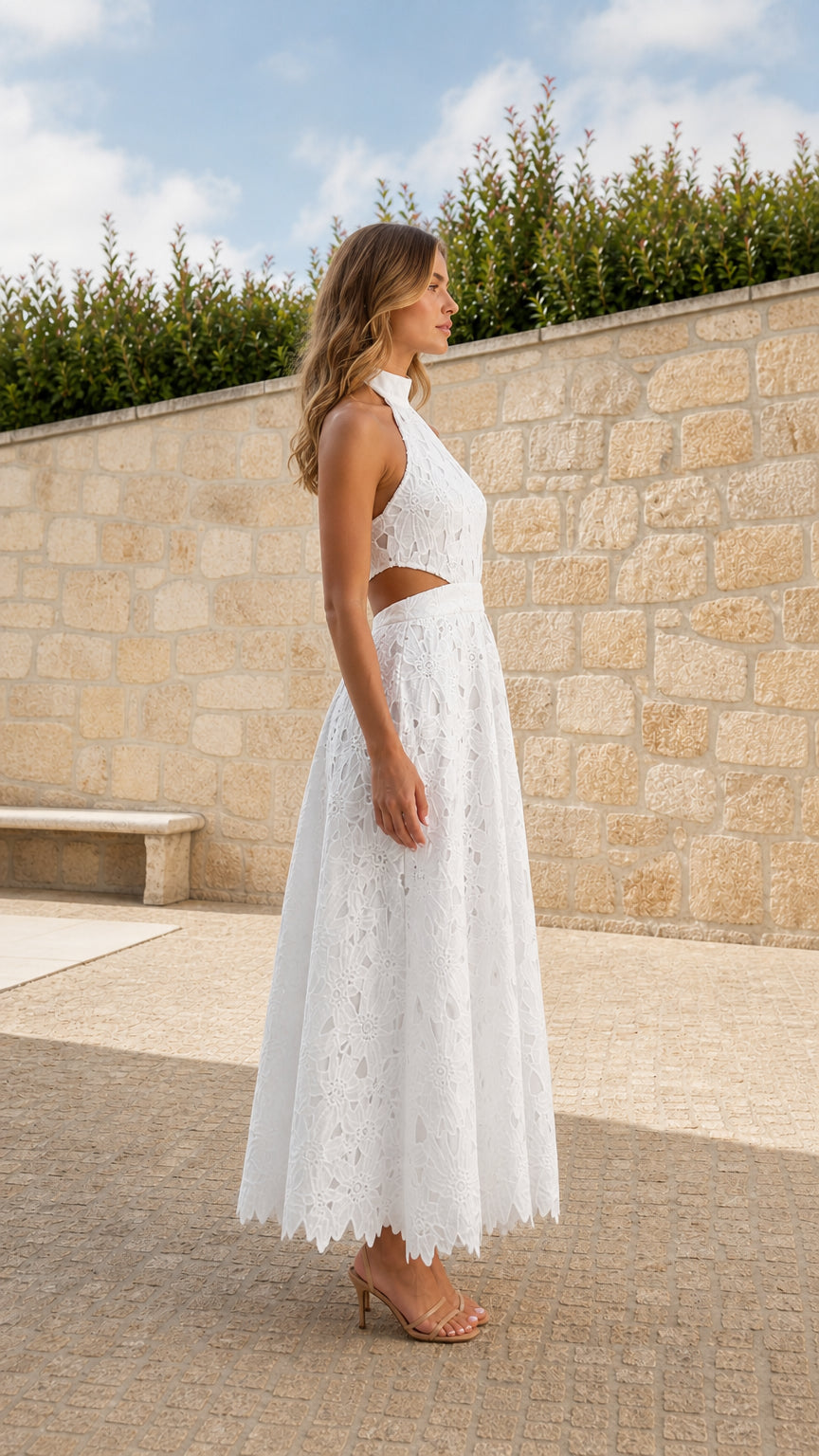 Side profile of model wearing White halter lace maxi dress