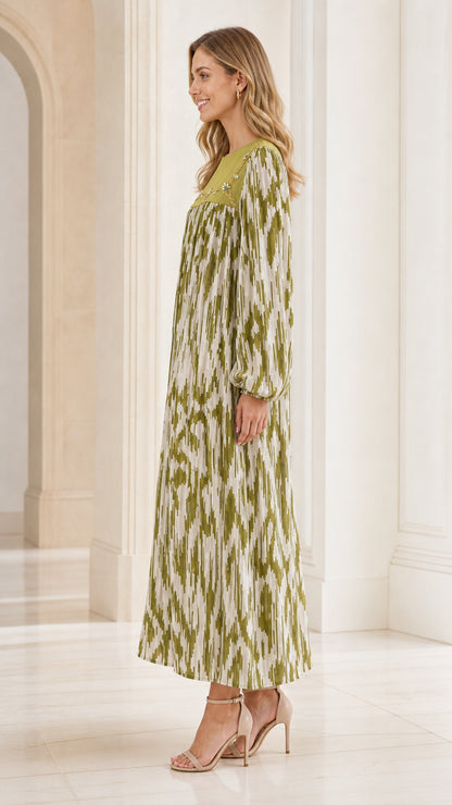 Side profile of woman wearing olive green long sleeve pleated maxi dress