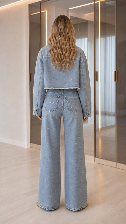 Back view of model wearing Light Blue cropped denim jacket and wide-leg pants with rhinestone details