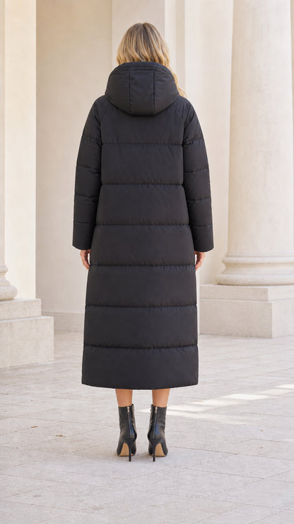 Back view of model wearing full-length black quilted winter puffer coat