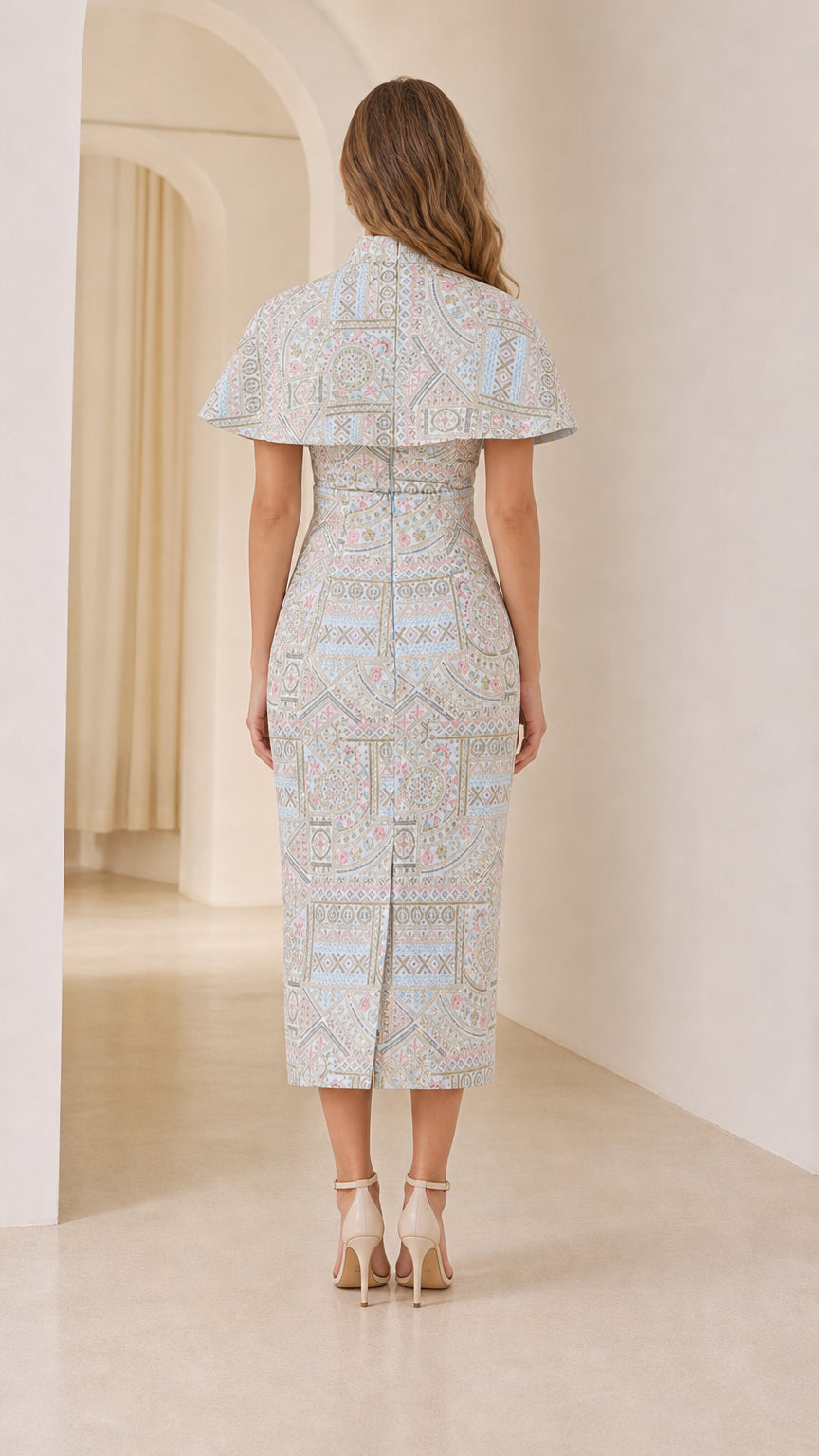 Back view of model in Light Blue jacquard midi dress with capelet and back vent
