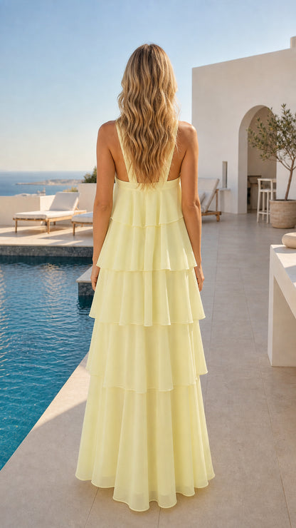 Back view of light yellow strappy halter tiered ruffle maxi dress