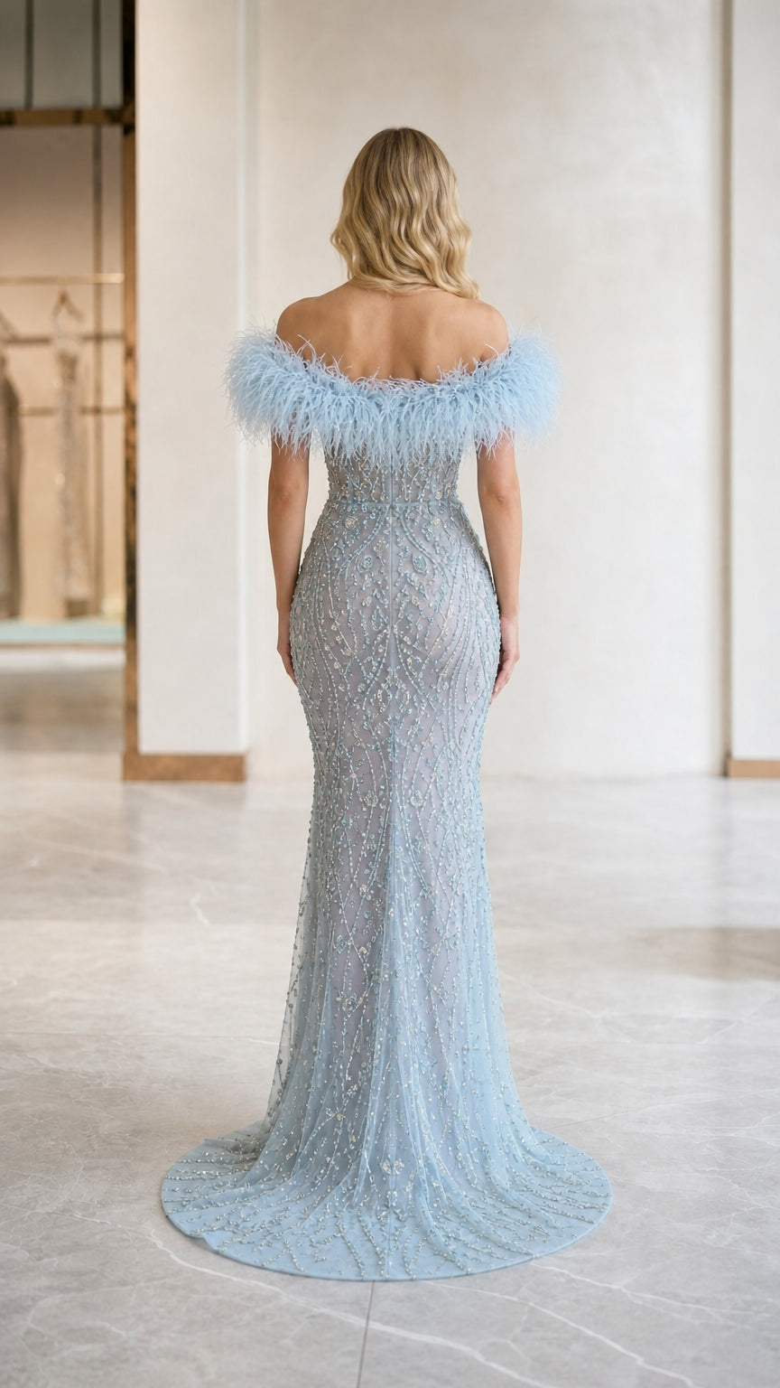 Back view of light blue embellished evening gown with train