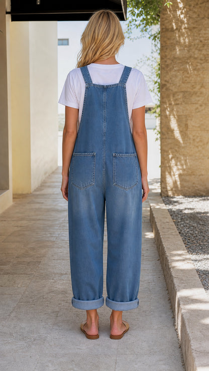Back view of model wearing blue denim overalls