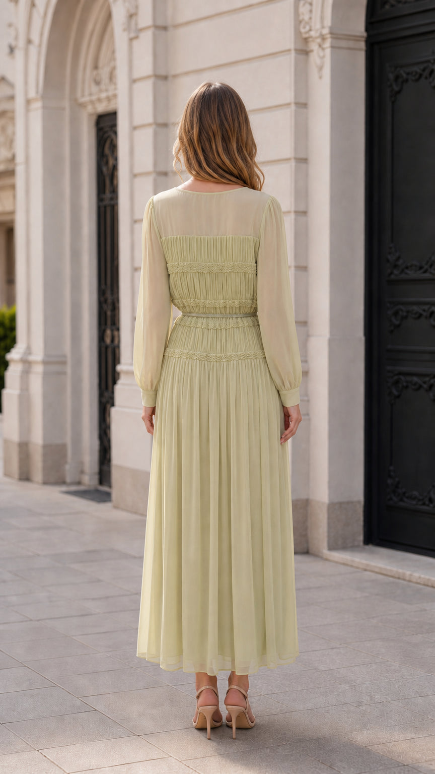 Back view of model in sage green pleated maxi dress