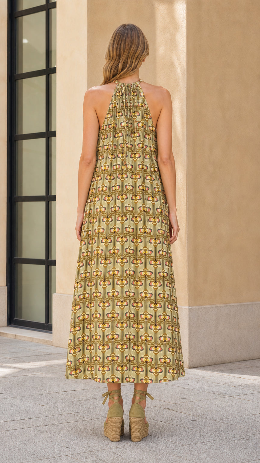 Back view of olive geo print halter maxi dress