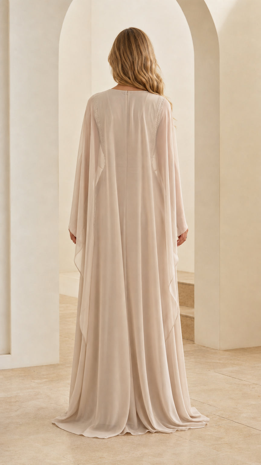 Back view of champagne formal gown showing flowing sheer chiffon cape overlay