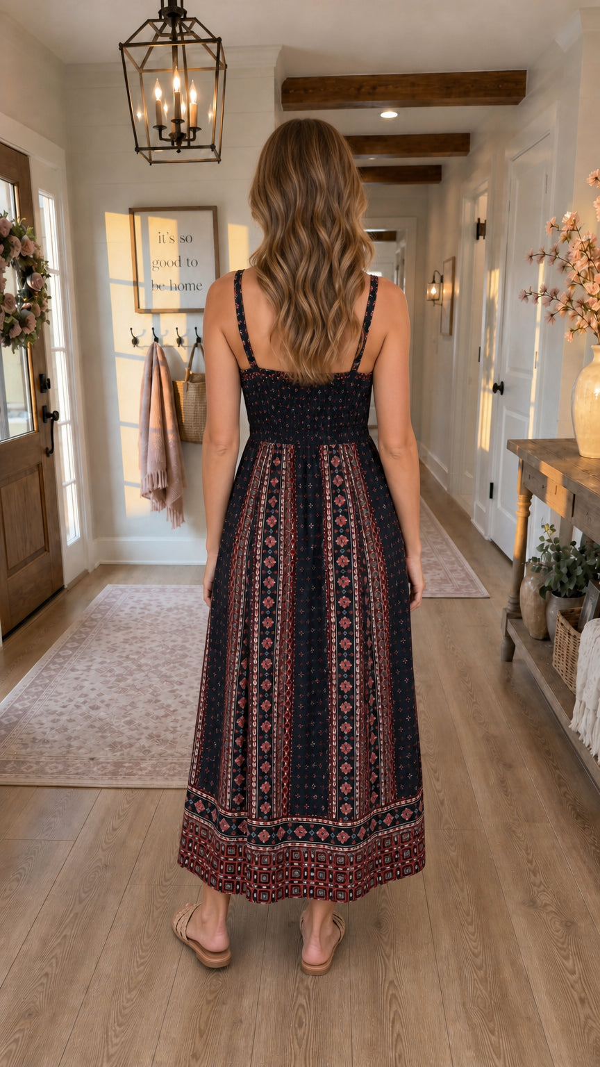 Back view of model in black printed midi dress