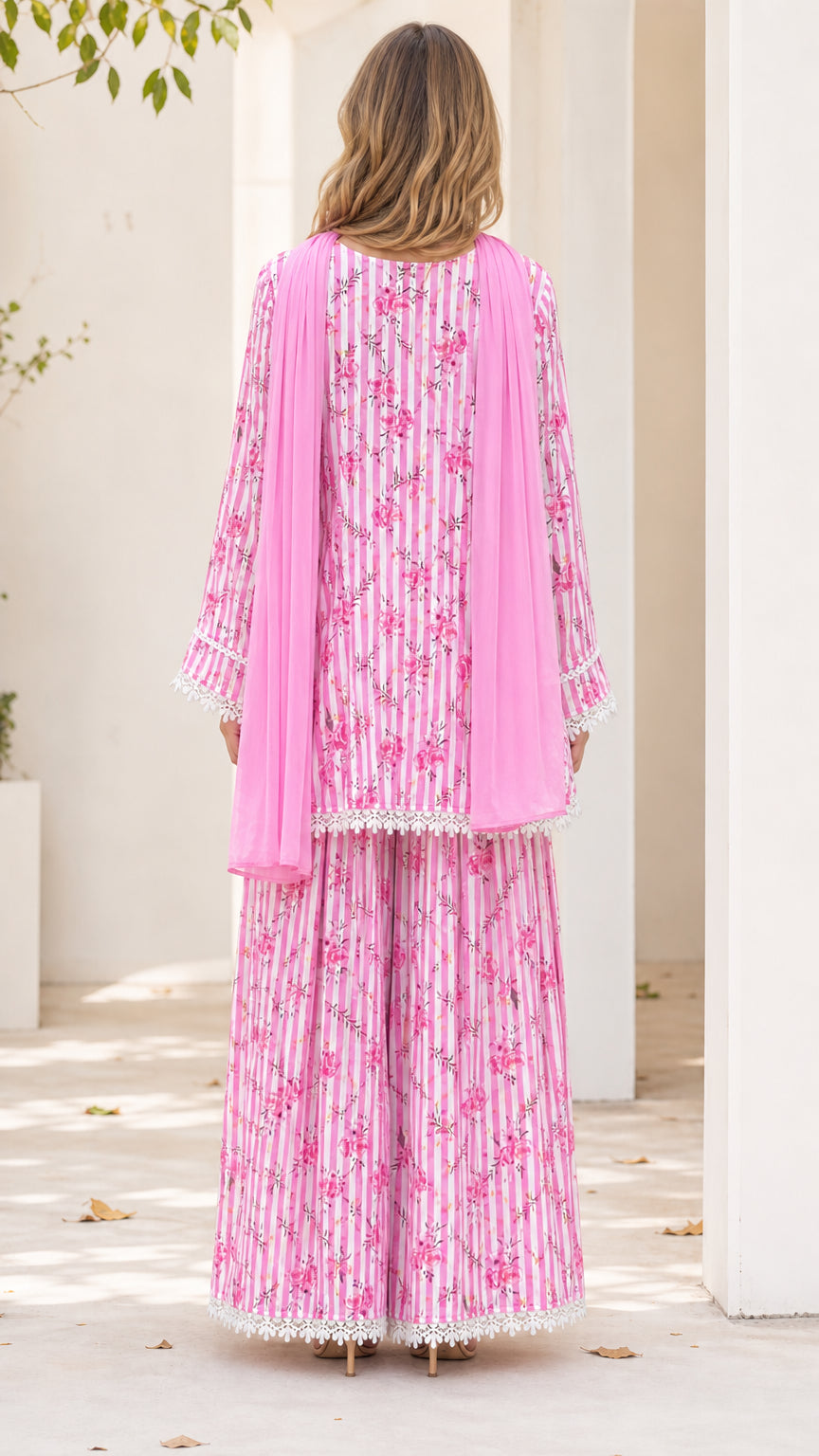 Back view of model wearing pink floral tunic and wide-leg trousers