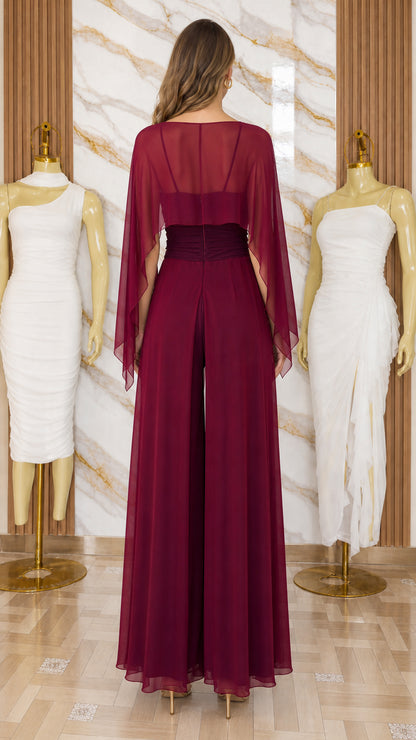 Model wearing burgundy chiffon jumpsuit back view